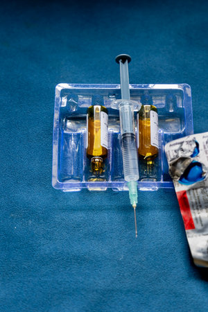 medicine tablet leaf with syringe and empty drug bottle indoorsの写真素材