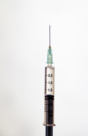 medical injection filled with drug ready to use under bright lightの写真素材