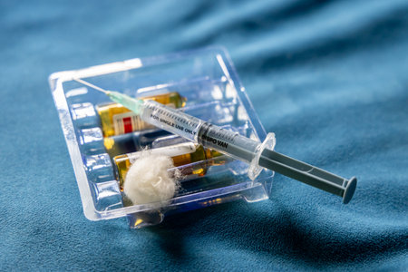 used injection and empty medicine vial in clinical settingの写真素材