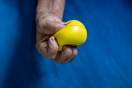 muscle strengthening exercise with stress ball indoorsの写真素材