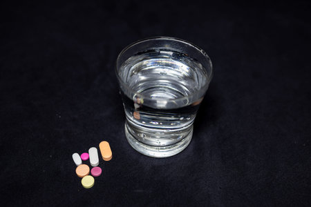 colorful medicine and water glass at indoor setup