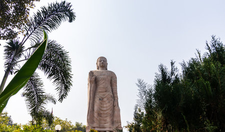 ancient giant buddha statue stone architecture with bright sky background from unique perspective at Sarnath near Varanasi, India.の写真素材