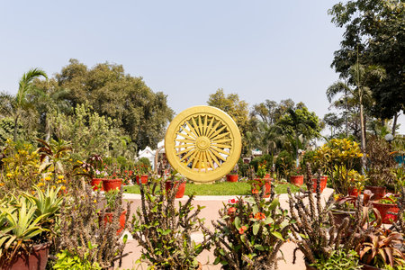 indiaâs ashoka wheel etched in stone amid scenic greenery at Sarnath near Varanasi, India.の写真素材