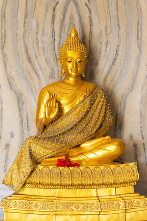 divine golden buddha seated in holy position at monasteryの写真素材