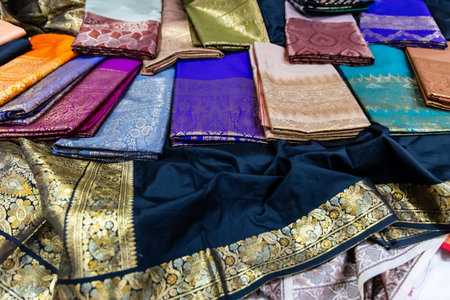authentic traditional varanasi silk saree in different colors for sale at indoor lightingの写真素材