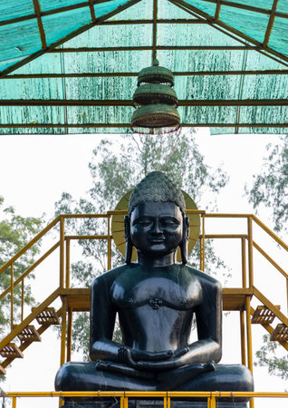 holy black stone buddha sculpture at outdoor at day at Sarnath near Varanasi, India, marking the sacred site where Buddha gave his first sermon.の写真素材