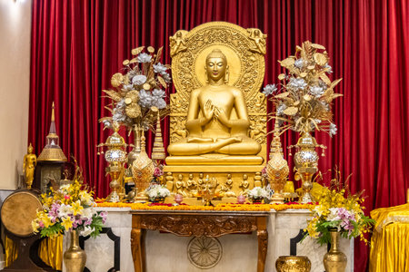 isolated holy statue of golden buddha at monastery at indoorの写真素材