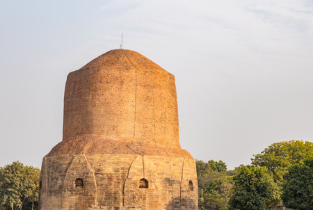 holy sarnath dhamek stupa buddhist monument with clear sky in daylight at Sarnath near Varanasi, India, marking the sacred site where Buddha gave his first sermon.の写真素材