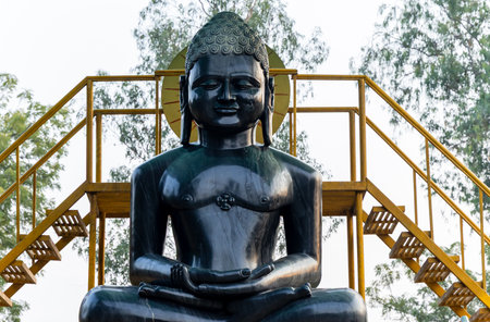 ancient black marble statue of buddha at outdoor in day at Sarnath near Varanasi, India, marking the sacred site where Buddha gave his first sermon.の写真素材