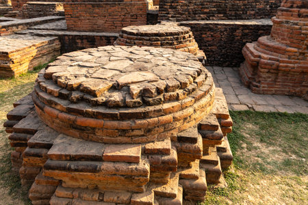 sarnath archaeological remains with small meditation stupa in sunlightの写真素材