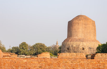 holy sarnath dhamek stupa buddhist monument with clear blue sky in daylight at Sarnath near Varanasi, India, marking the sacred site where Buddha gave his first sermon.の写真素材