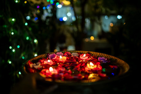 festive diwali night decor with glowing candles and rose petals indoors