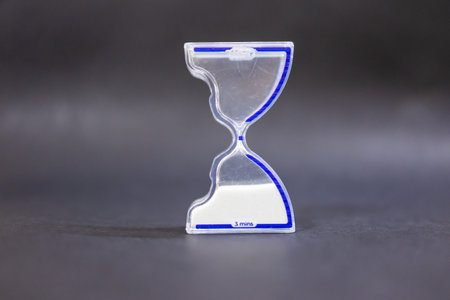 transparent hourglass on dark background for efficiency and planningの写真素材