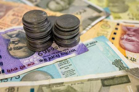Stacked Coins On Indian Rupee Banknotesの写真素材