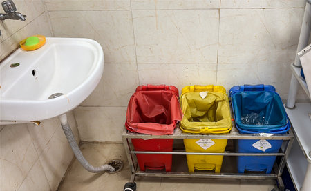biomedical waste bins red, yellow, blue for segregation with hospital hand washingの写真素材