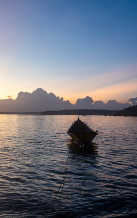 traditional wooden boats floating on low light water