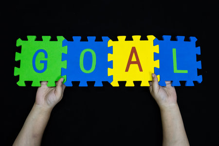 success and achievement concept goal letters on interlocking tilesの写真素材