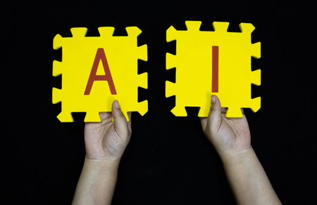 artificial intelligence concept hands displaying foam alphabet tiles for aiの写真素材
