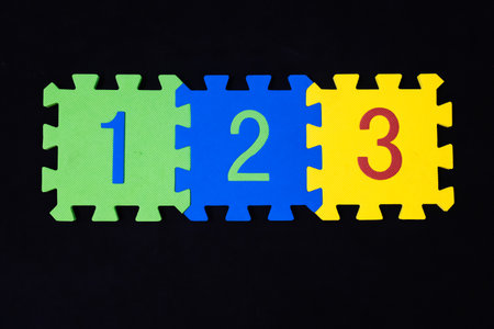 education and learning numbers 1 2 3 on colorful puzzle piecesの写真素材