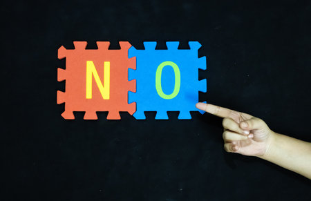 rejection and opposition word no on contrasting puzzle piecesの写真素材