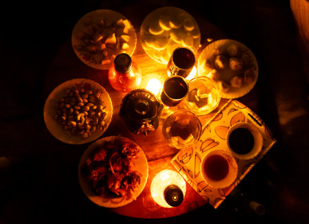 romantic dinner party celebration with glasses filled with drinks and snacksの写真素材