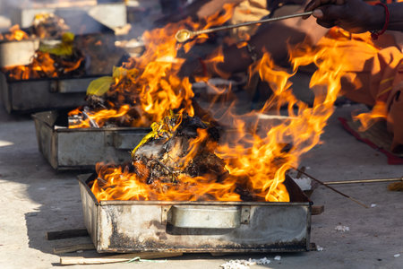 closeup of agnihotra ceremony with blazing sacred fire and ritual offeringsの写真素材