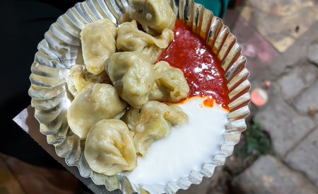 closeup of traditional indian street momos with chili chutneyの写真素材