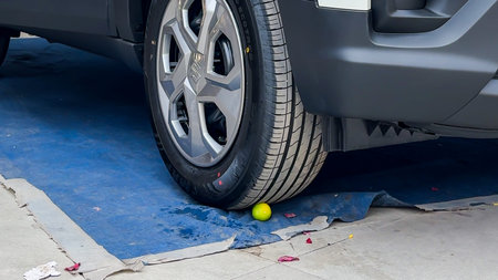 closeup of automobile tyre over lemon for auspicious ceremony