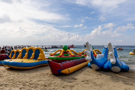 vibrant beach water sports setup with inflatable rides and boats by sea shot is taken at Elephant...
