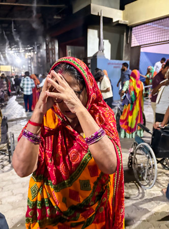 worshippers offering prayers during temple aarti ritual with sacred flame shot is taken at chaturdas...