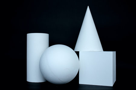 Plaster figure sphere, cone, cube, cylinder isolated on the black background.の写真素材