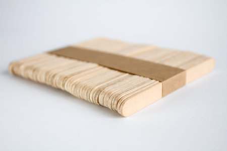 Row of wooden sticks isolated on white background