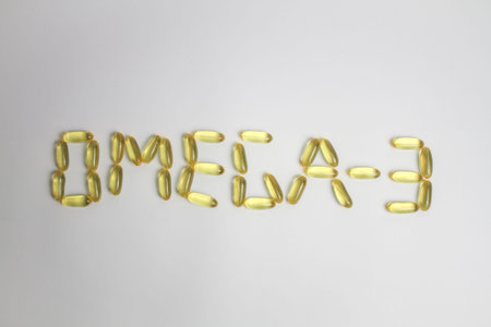 Fish oil capsules saying OMEGA-3 on the white background