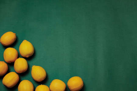 Pile of fresh lemons on the green backgroundの写真素材