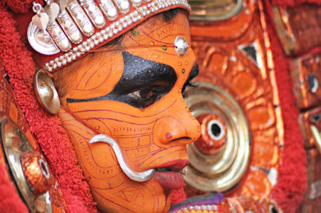 KANNUR, INDIA - NOVEMBER 28, 2011  an unidentified Theyyam performer in full costume during a performance of Hindu religious dance and drama on November 28, 2011 near a village in Kannur, India  のeditorial素材