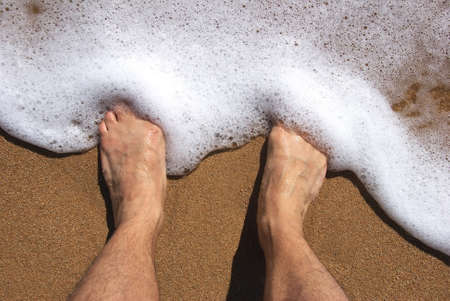 feet in the water of the seaの写真素材