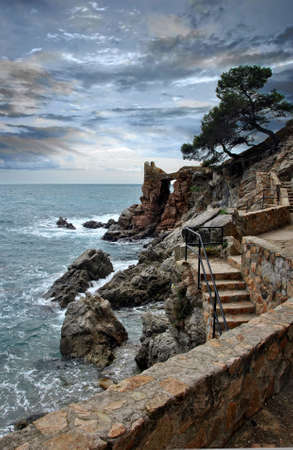 Stairs leading down to the beach on the costa brava in LLoret de marの写真素材