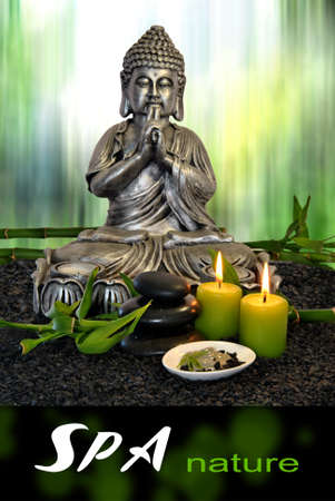 Buddha  with massage stones and green clay with candlesの写真素材