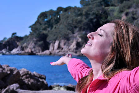woman relaxing in the sea and doing meditationの写真素材