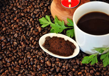 cup of tea with candle and grains aroundの写真素材