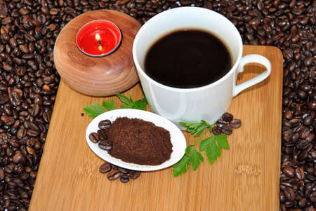 cup of tea with candle and grains aroundの写真素材