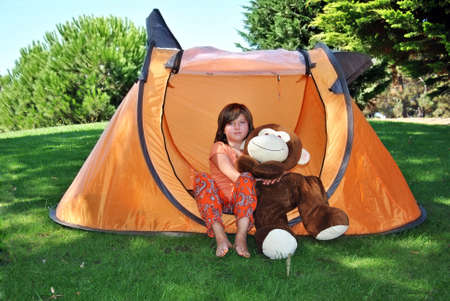 girl with teddy on the field in full Springの写真素材