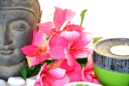 massage bath salt with pink flowers and Buddha statueの写真素材