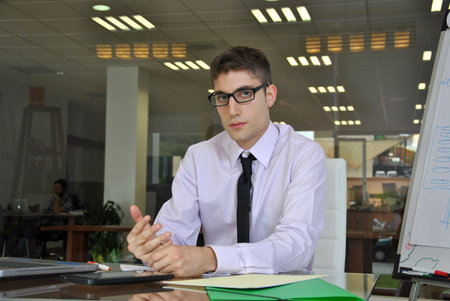businessman sitting in his office looking at his work