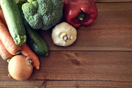 various types of vegetables on a wooden boardの写真素材