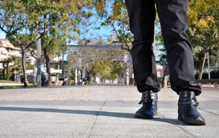 legs of young man walking around townの写真素材