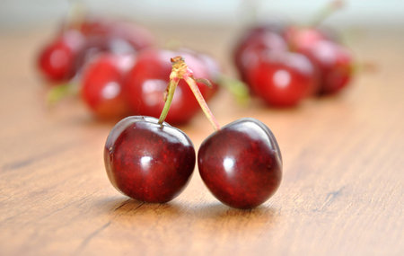 many cherries in a wooden bowl on a table
