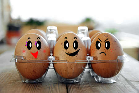 eggs tucked in its box on a wooden tableの写真素材