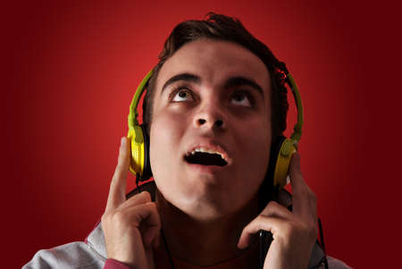 youn man listening to music with headphonesの写真素材