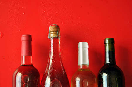 cold bottles of wine glass and grapes aroundの写真素材